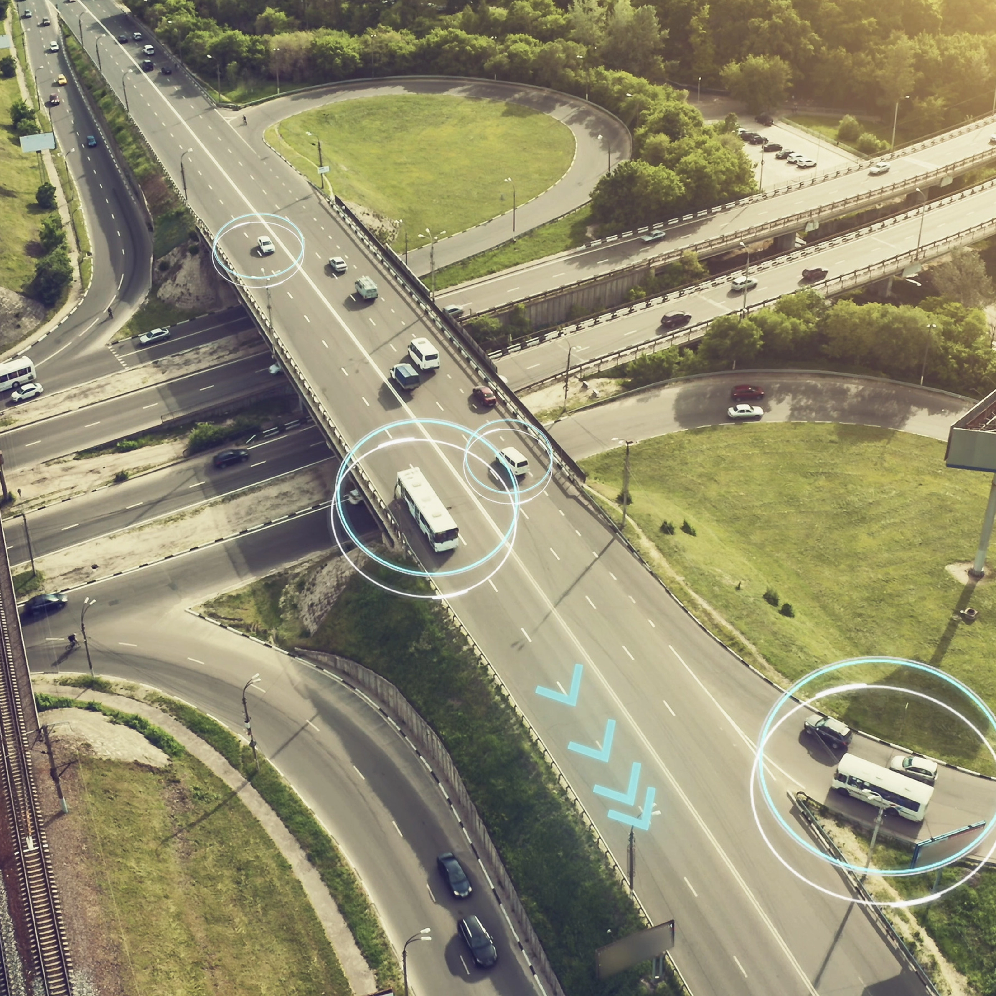 Aerial view of a highway interchange with marked autonomous vehicles.