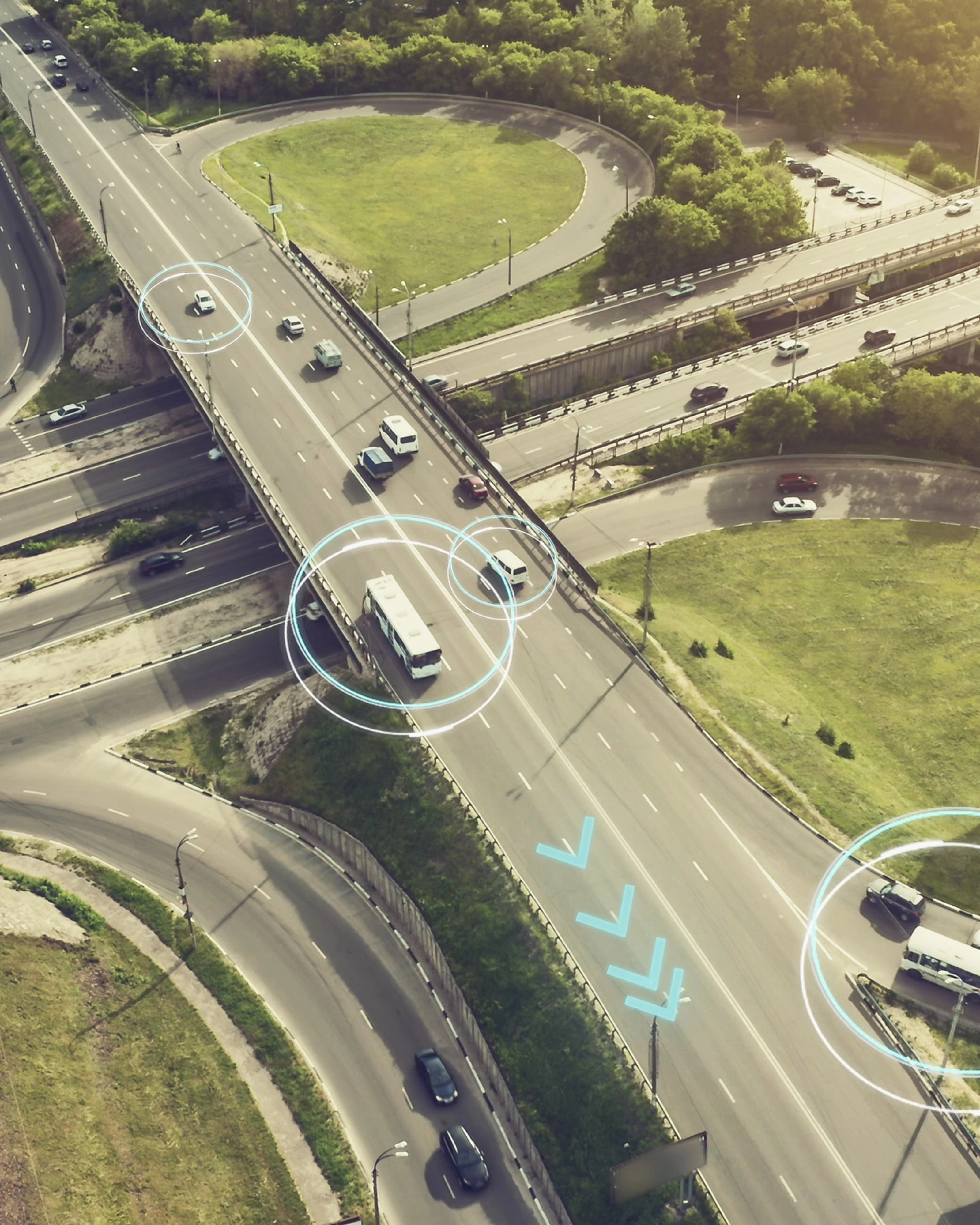 Aerial view of a highway interchange with marked autonomous vehicles.